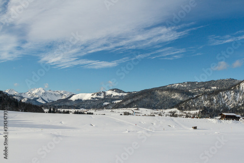 winter landscape with a snow-covered house in the ski area reit im winkl