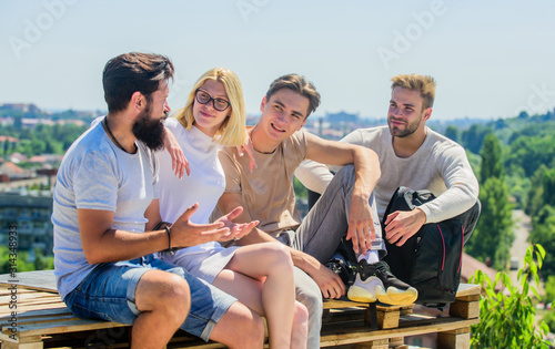 Men and woman talking nature background. Spending time with friends. Discussing ideas. Summer vacation. Cheerful friends relaxing. Carefree friends. True friendship. Being sincere with closest people