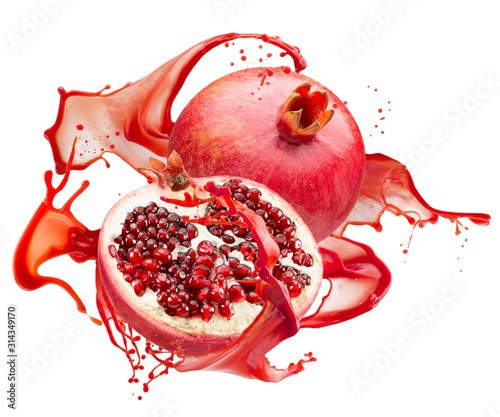 pomegranates in red juice splash isolated on a white background photo