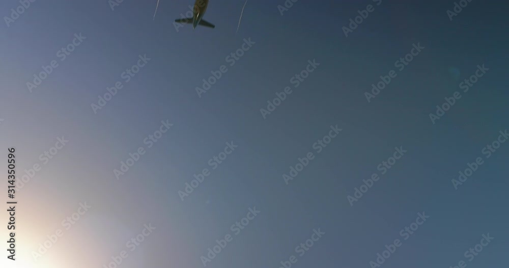 Large passenger airplane taking off or landing against beautiful blue sky with white clouds. Traveling by air flight. Freight aircraft transportation cargo. Start of the journey. End of the vacation.