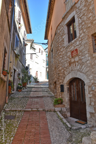 A narrow street between the old houses of a medieval town in Italy © Giambattista
