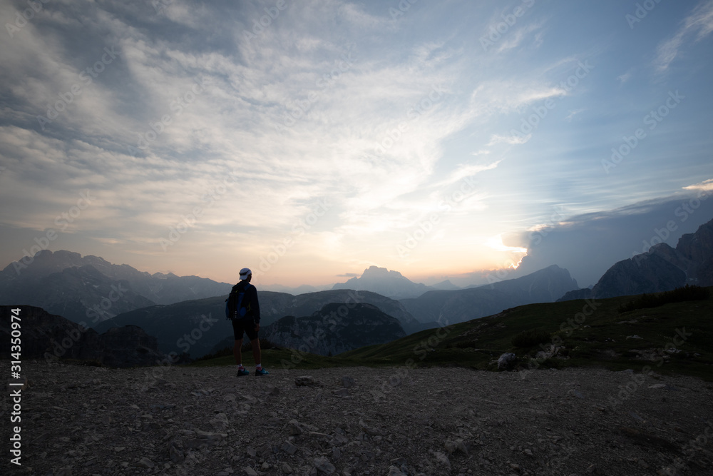 Fototapeta premium Sunset at Dolomites mountains Italy with person 