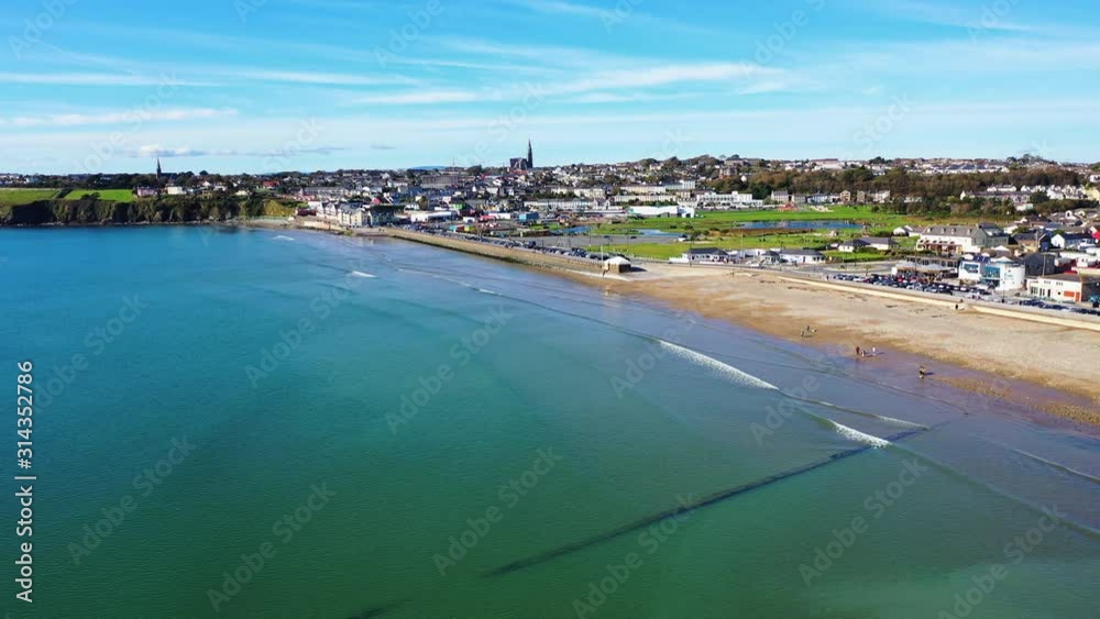Aerial tracking shot of Tramore Beach in Ireland during beautiful sunny day. Aerial tracking shot of Tramore Beach in Ireland during beautiful sunny day.