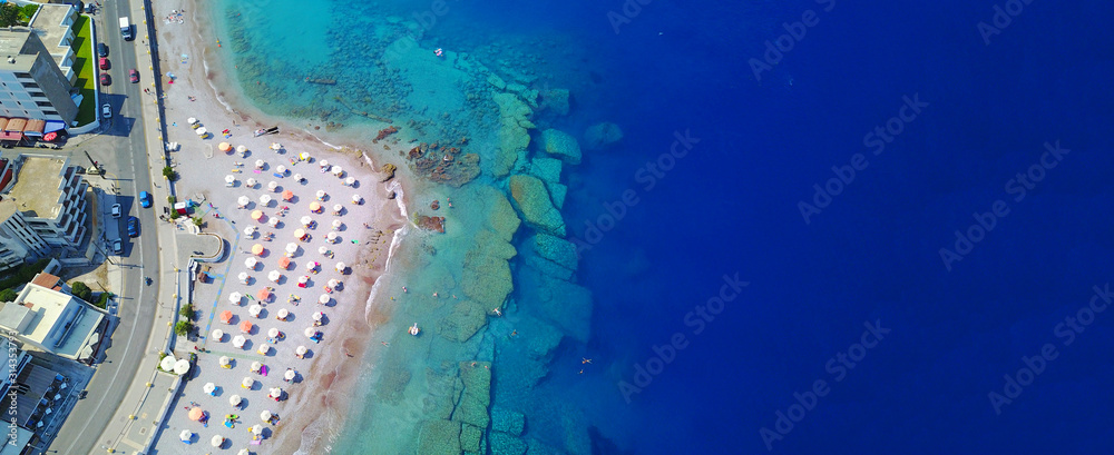Aerial drone ultra wide top down photo of popular crowded Elli beach in main peninsula of Rodos island, Dodecanese, Greece