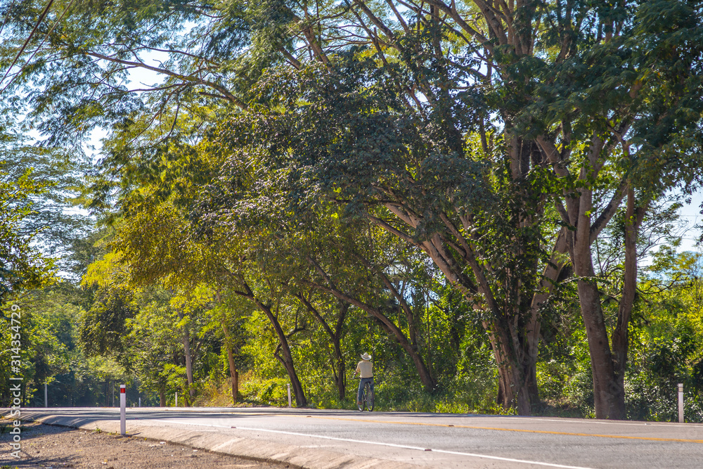 A local cyclist with a hat on the roads of Copan Ruinas. Honduras