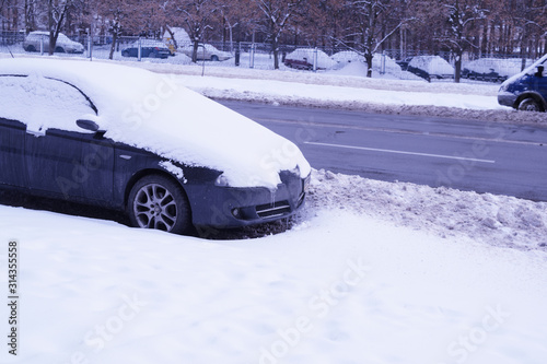 View of the car in the snow near the road.