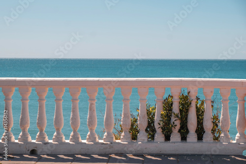 white stairs railings on blue sea background in Spain, copy space