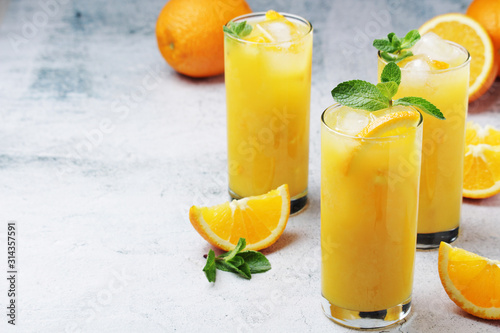 Glasses full of orange juice with ice	