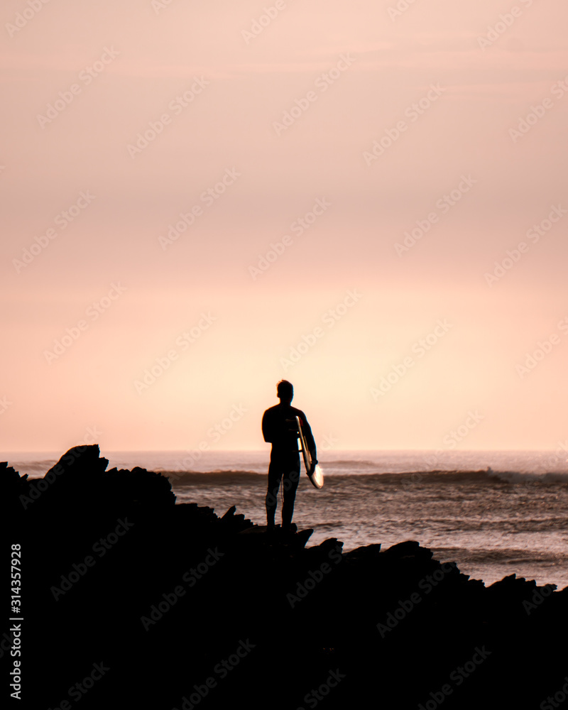 silhouette of surfer in the beach, beautiful sunset in Peru.  