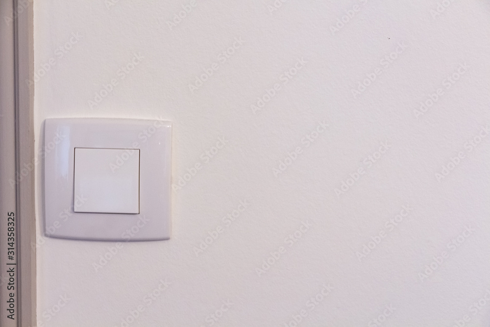 White switch made in plastic in a wall White switch made in plastic in a wall