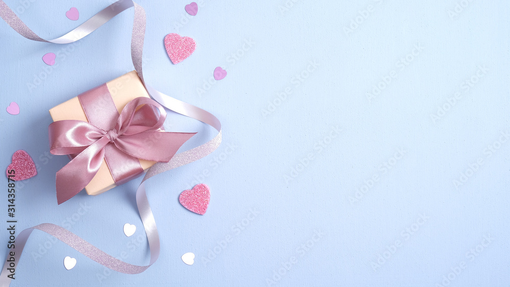 Fototapeta premium Valentines day background with gift box, ribbon, pink hearts. Valentines day surprise. Banner mockup for St Valentines day, Birthday or Mothers Day