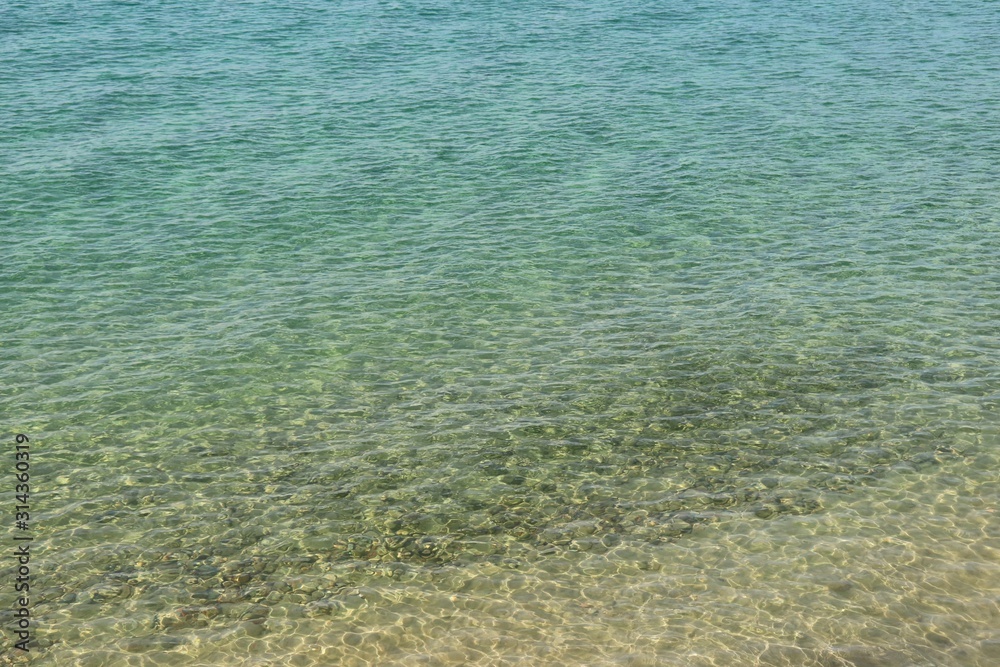Sandy beach and turquoise clear warm water on the island of Corsica in the Mediterranean Sea Sandy beach and turquoise clear warm water on the island of Corsica in the Mediterranean Sea