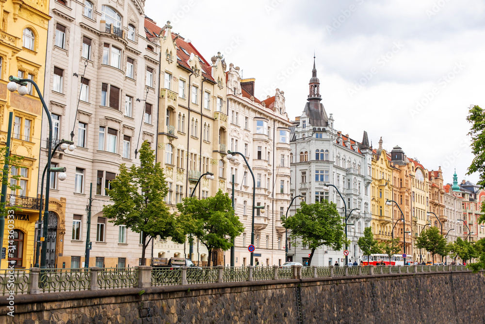 Prague embankment on a summer day. Panorama of the city. Beautiful buildings.