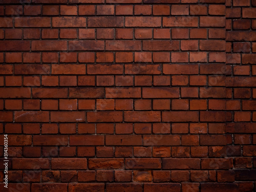 Old european red brick wall on building corner, abstract vintage grunge background texture.