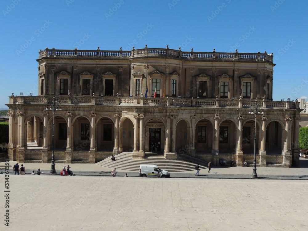 Noto – Town Hall palace facade in baroque style with the staircase, gallery with columns and balcony