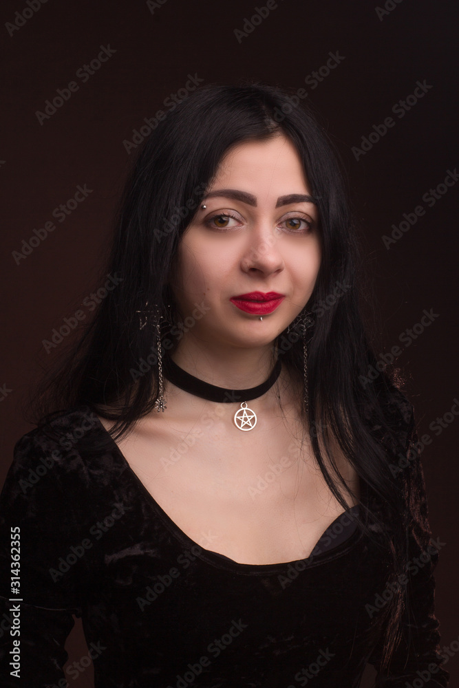 brunette on dark background dressed in goth style