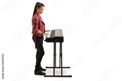 Young woman playing a digital piano photo