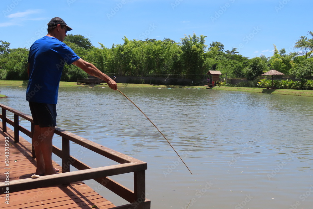 man fishing on pier