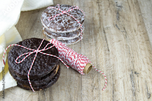 Chocolate ginger biscuits bandaged with red-and-white thread with thred photo