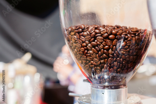 Fresh coffee beans in a grinder © filirovska
