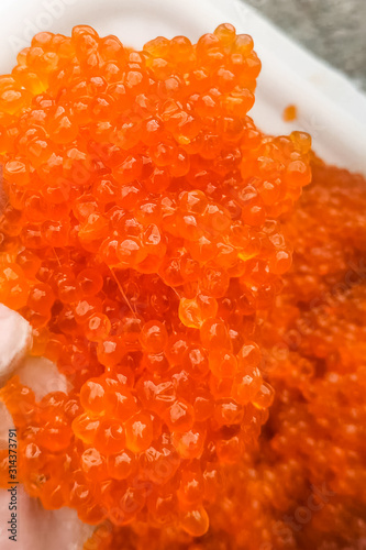 red caviar in plastic container. Salmon caviar, diet food.