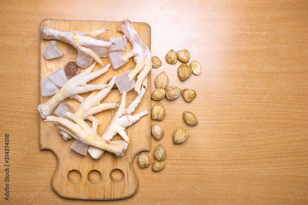 Chicken legs on a cutting board.