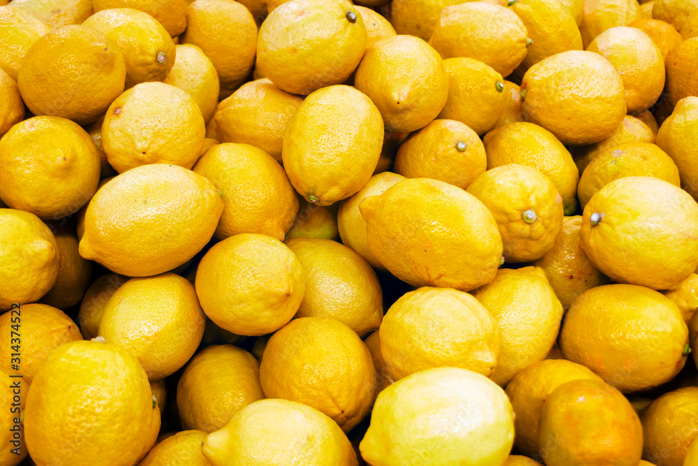 Fresh yellow lemons on a supermarket counter. Closeup.