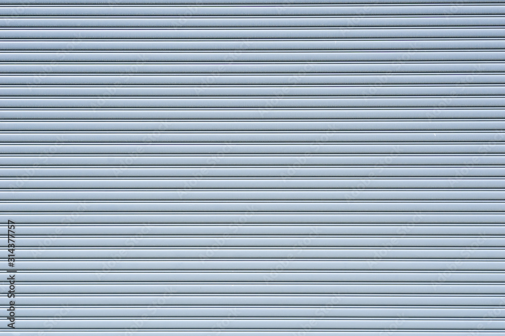 Automatic shutter door on front of factory or garage building Automatic shutter door on front of factory or garage building
