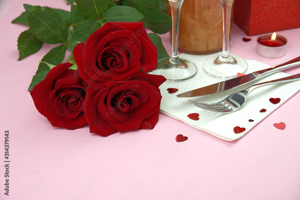 a composition of a beautiful bouquet of roses, glasses and a bottle of champagne creates a romantic card or poster. The concept of st valentine's day, Mother's Day, March 8. a composition of a beautiful bouquet of roses, glasses and a bottle of champagne creates a romantic card or poster. The concept of st valentine's day, Mother's Day, March 8.