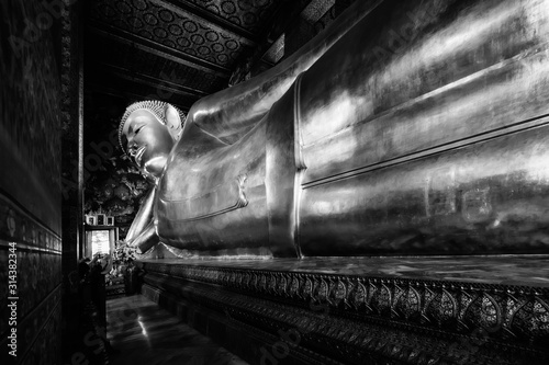 Photography famous golden reclining buddha statue at wat pho bangkok thailand in black and w