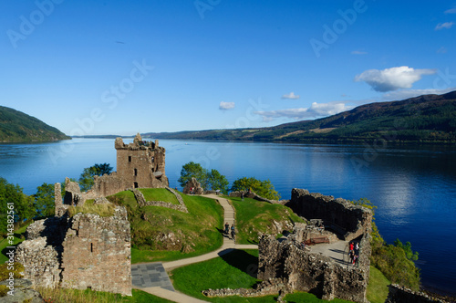 Ruins of Urquhart Castle on the shores of Loch Ness in the Scottish Highlands, with a beautiful blue sky in the summer. Drumnadrochit, Inverness, Scotland photo
