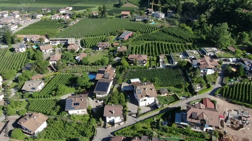 Small village in north of Italy with many apple trees between the houses. It`s spring and eveything is green and alive. Few build sides. photo