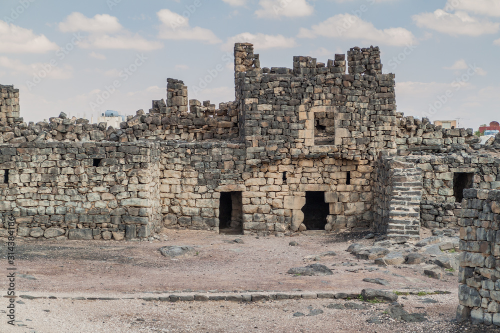 Ruined walls of Qasr al-Azraq (Blue Fortress), located in the desert of eastern Jordan. Ruined walls of Qasr al-Azraq (Blue Fortress), located in the desert of eastern Jordan.