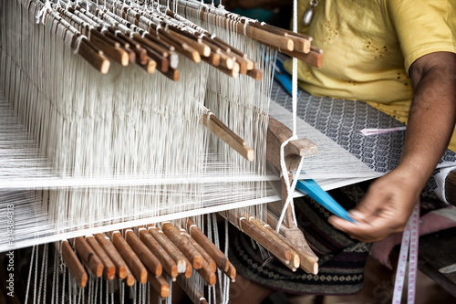 Fotografija weave silk cotton on the manual wood loom ,Thailand,selective focus,vintage colo