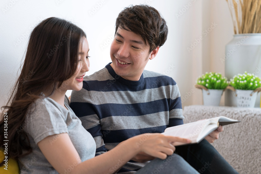 Asian couples spend time together at home, They read books together, The concept of living together. Asian couples spend time together at home, They read books together, The concept of living together.