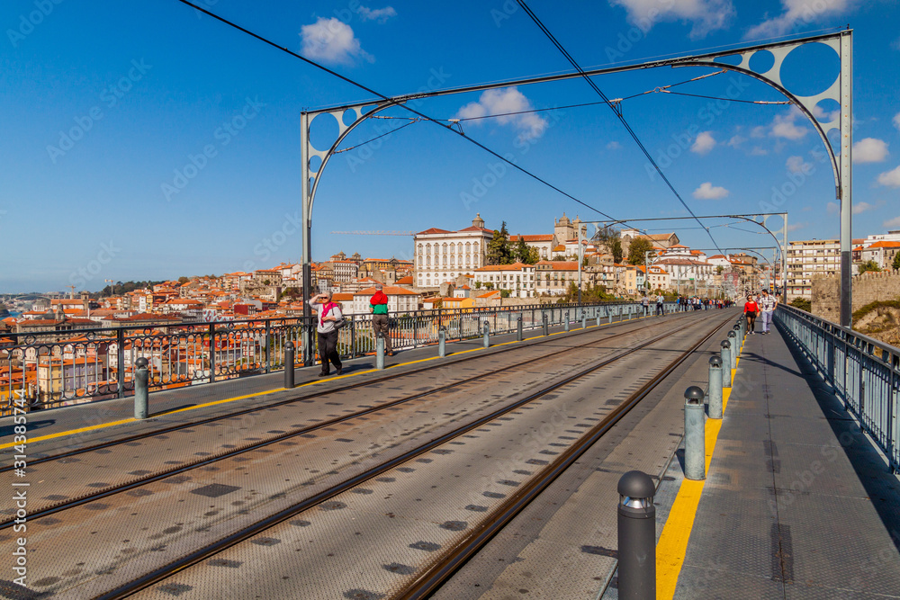 PORTO, PORTUGAL - OCTOBER 18, 2017: People walk at Dom Luis bridge in Porto, Portugal