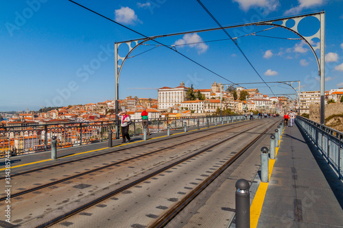 PORTO, PORTUGAL - OCTOBER 18, 2017: People walk at Dom Luis bridge in Porto, Portugal
