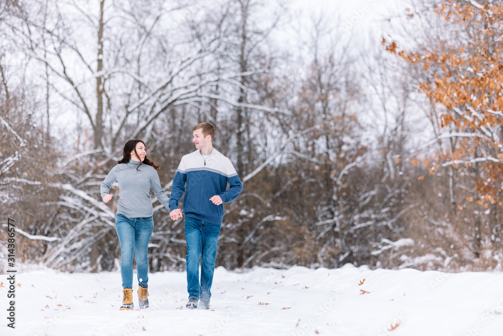 Love Valentine Concept. people, season, love and leisure concept. happy couple walking through the park on a snowy day. Romantic couple in love feeling happiness romance Valentine . love copy space.