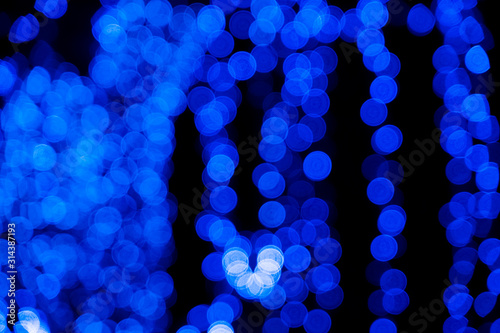 Defocused of blurred phantom blue bokeh circle light from lighting bulb in the dark night for abstract background texture patterns © 168 Studio