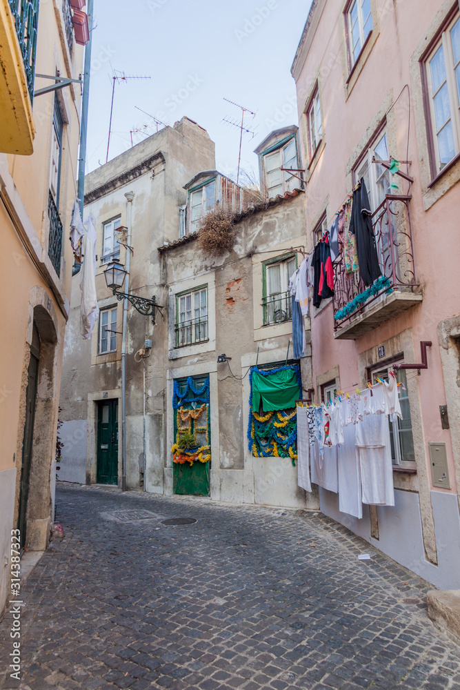 LISBON, PORTUGAL - OCTOBER 10, 2017: Narrow alley in Alfama neighborhood of Lisbon, Portugal