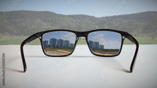 Abstract illustrations reflect the vision of a real estate developer.By reflecting the image of tall building construction through eyeglass lenses that see an undeveloped green area.