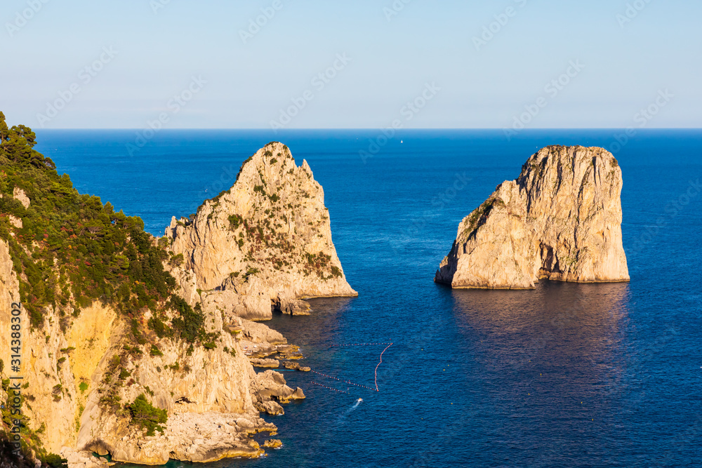 View of the Faraglioni, the signature sight of Capri. The three rock outcroppings peeking up from the sea create one of the most recognizable and captivating landscapes in the world.