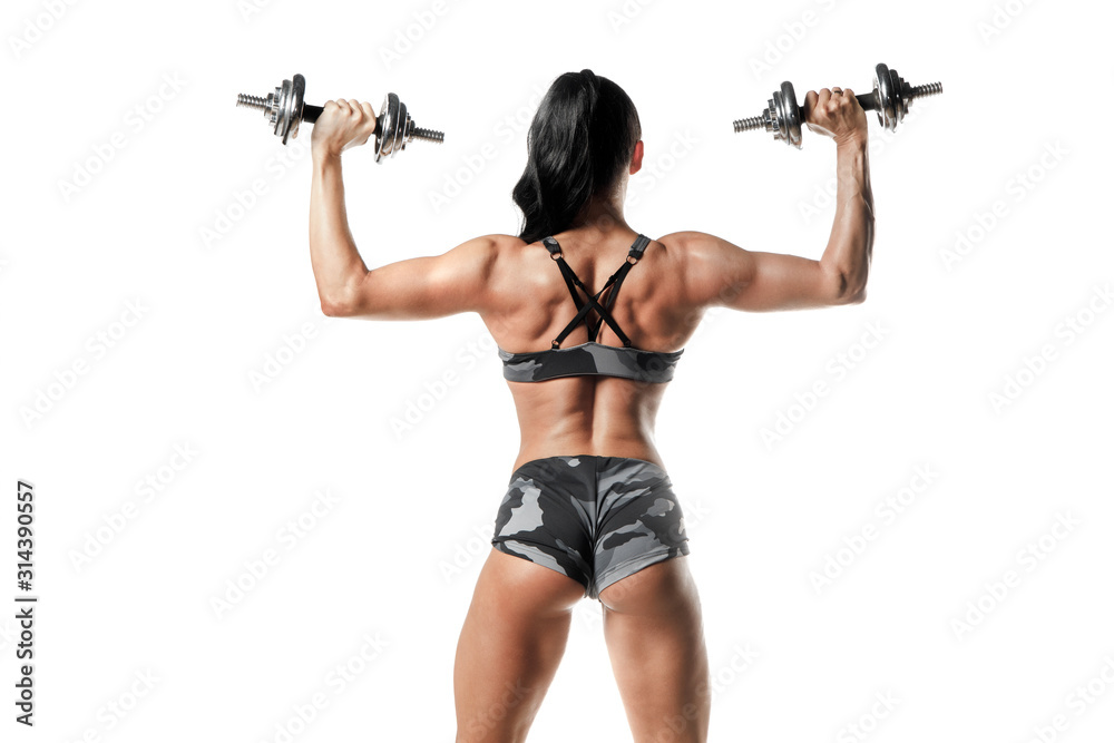 Sporty woman workout and posing. Fitness girl with perfect slim and fit body with dumbbells isolated Sporty woman workout and posing. Fitness girl with perfect slim and fit body with dumbbells isolated