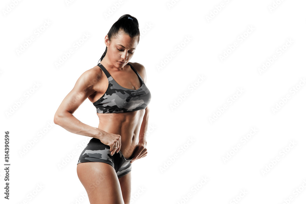 Sporty woman workout and posing. Fitness girl with perfect slim and fit body with dumbbells isolated Sporty woman workout and posing. Fitness girl with perfect slim and fit body with dumbbells isolated