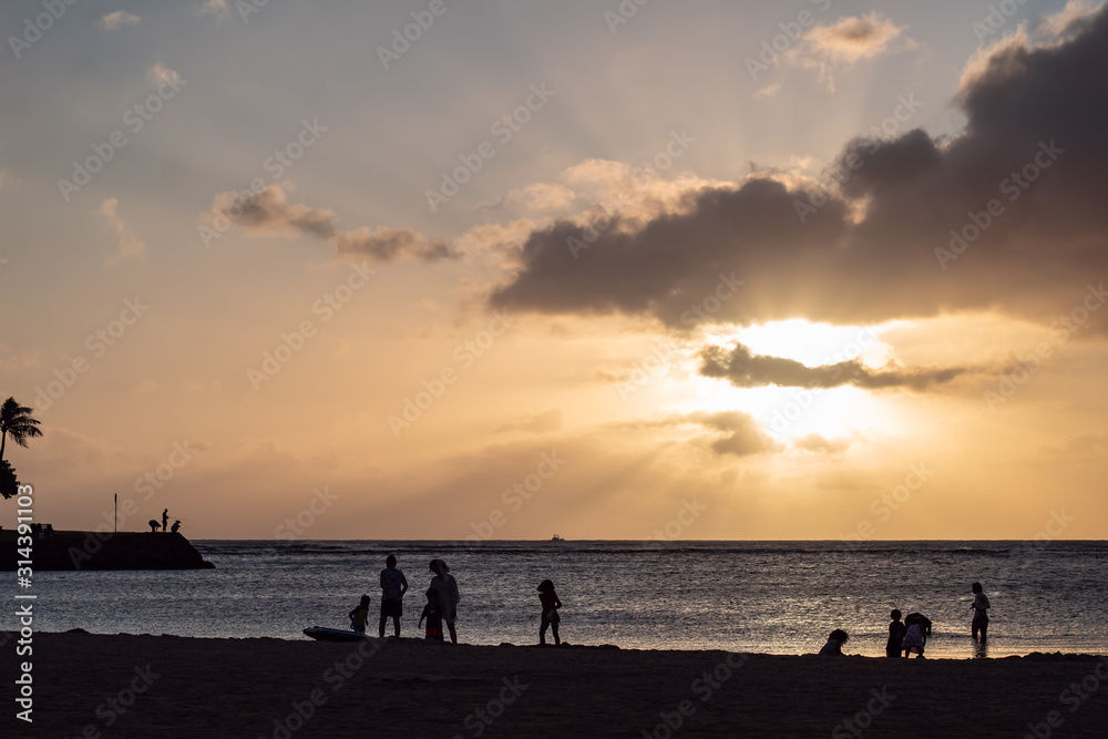 Sandy beach and ocean during sunset with clouds in the sky Sandy beach and ocean during sunset with clouds in the sky