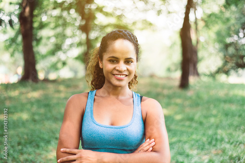 Attractive black woman smiles emotionally posing after break workout at outdoor,Positive thinking and smiling,Relax time