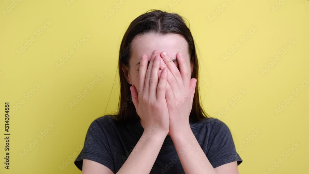 Happy woman blogger laughing out loud at humorous joke looking at camera on background yellow wall, cheerful casual young woman with funny face, enjoy sincere positive emotions. Happy woman blogger laughing out loud at humorous joke looking at camera on background yellow wall, cheerful casual young woman with funny face, enjoy sincere positive emotions.