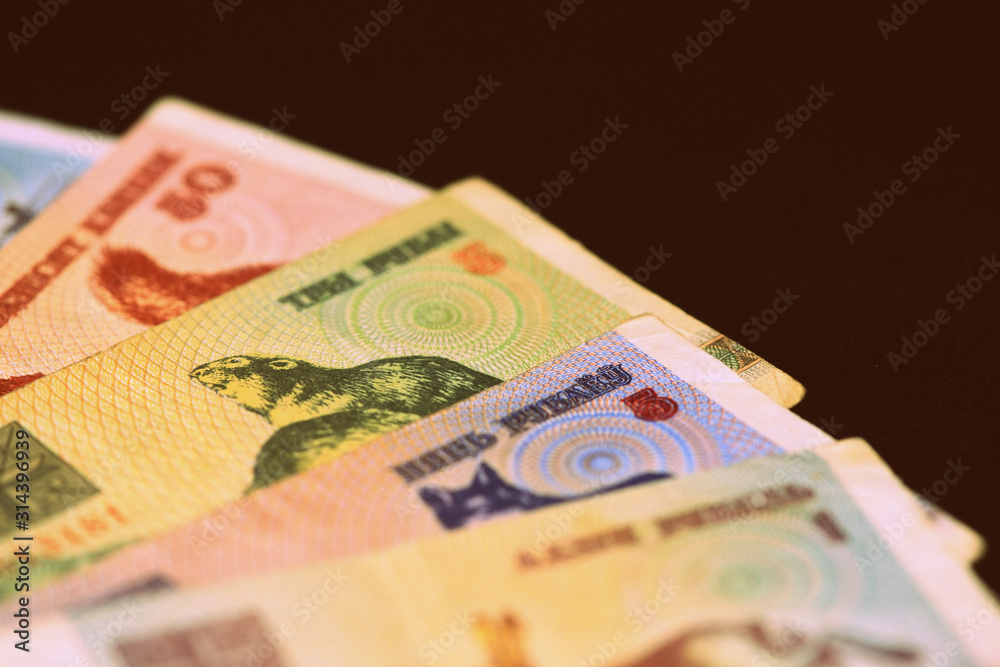 Fototapeta premium Outdated Belarusian rubles banknotes issued in the 90s. Money background retro style toned