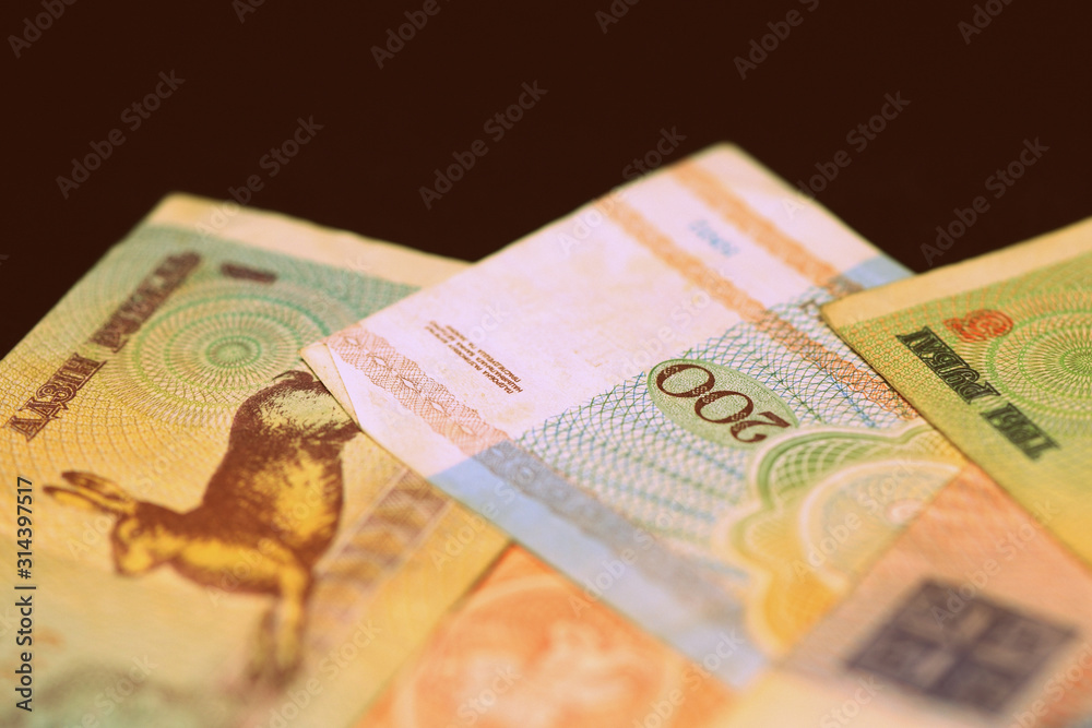 Fototapeta premium Outdated Belarusian rubles banknotes issued in the 90s. Money background retro style toned