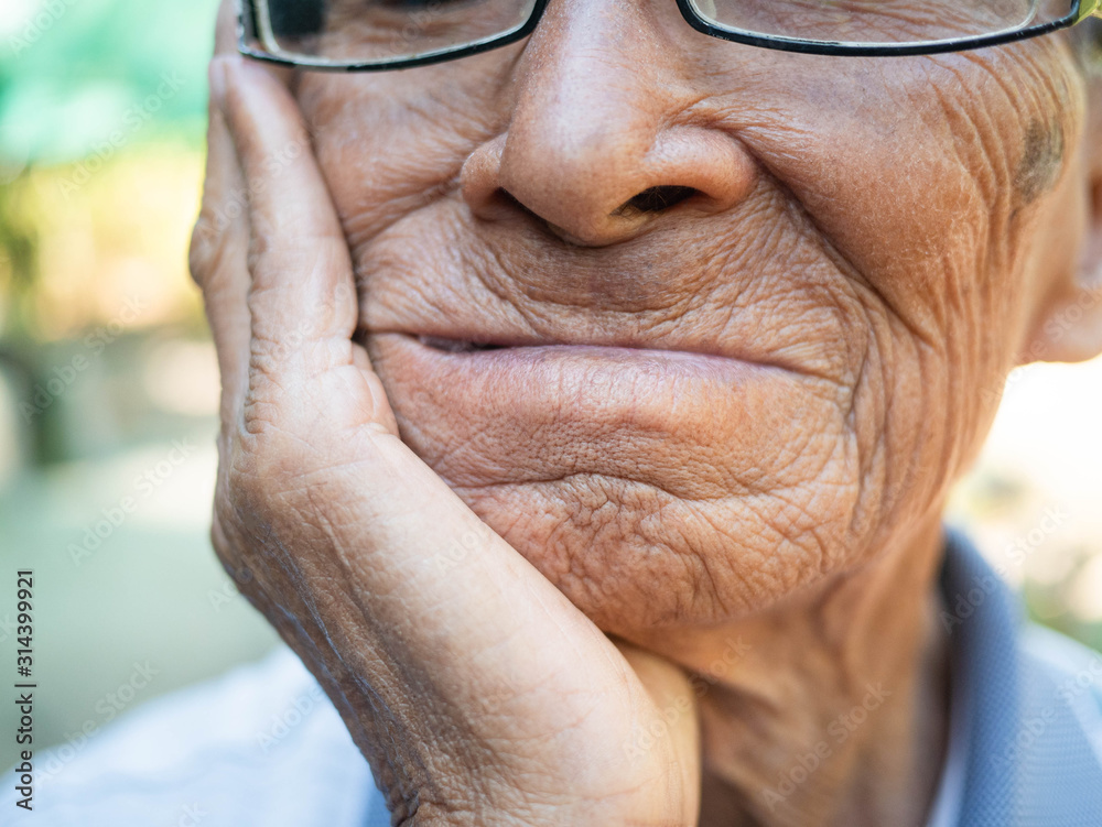 Close up of Elderly man biting on cotton gauze after tooth extraction
